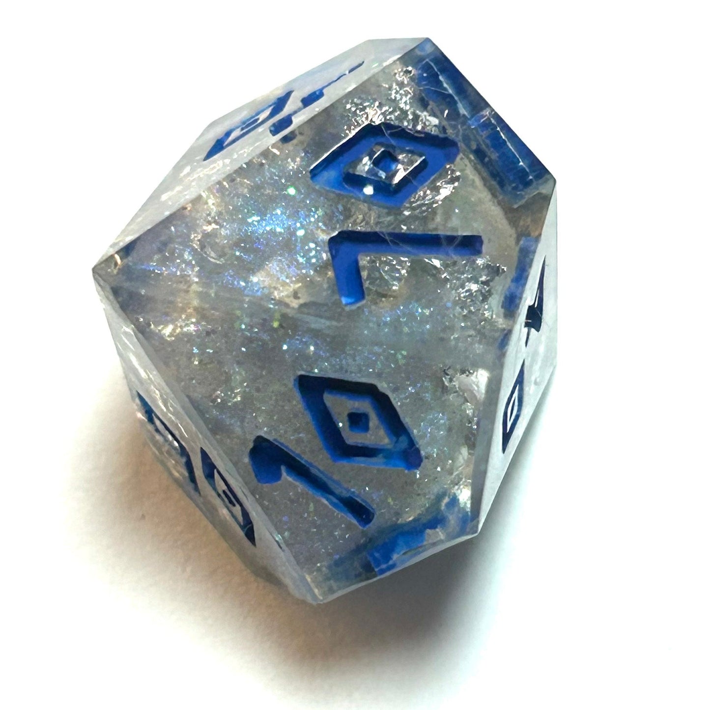 Clear resin dice d% with silver shimmer and deep blue numbering, resembling fractured ice — Infernal Crafts Glacial Veil handmade resin dice set.
