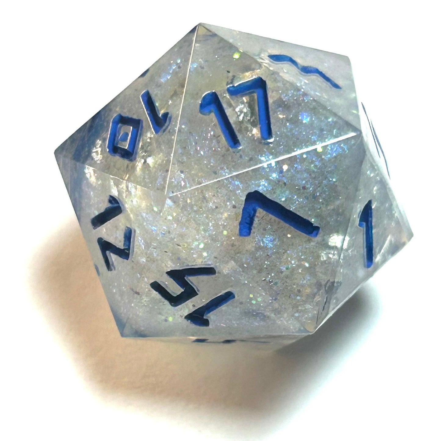 Clear resin d12 with silver shimmer and deep blue numbering, resembling fractured ice — Infernal Crafts Glacial Veil handmade resin dice