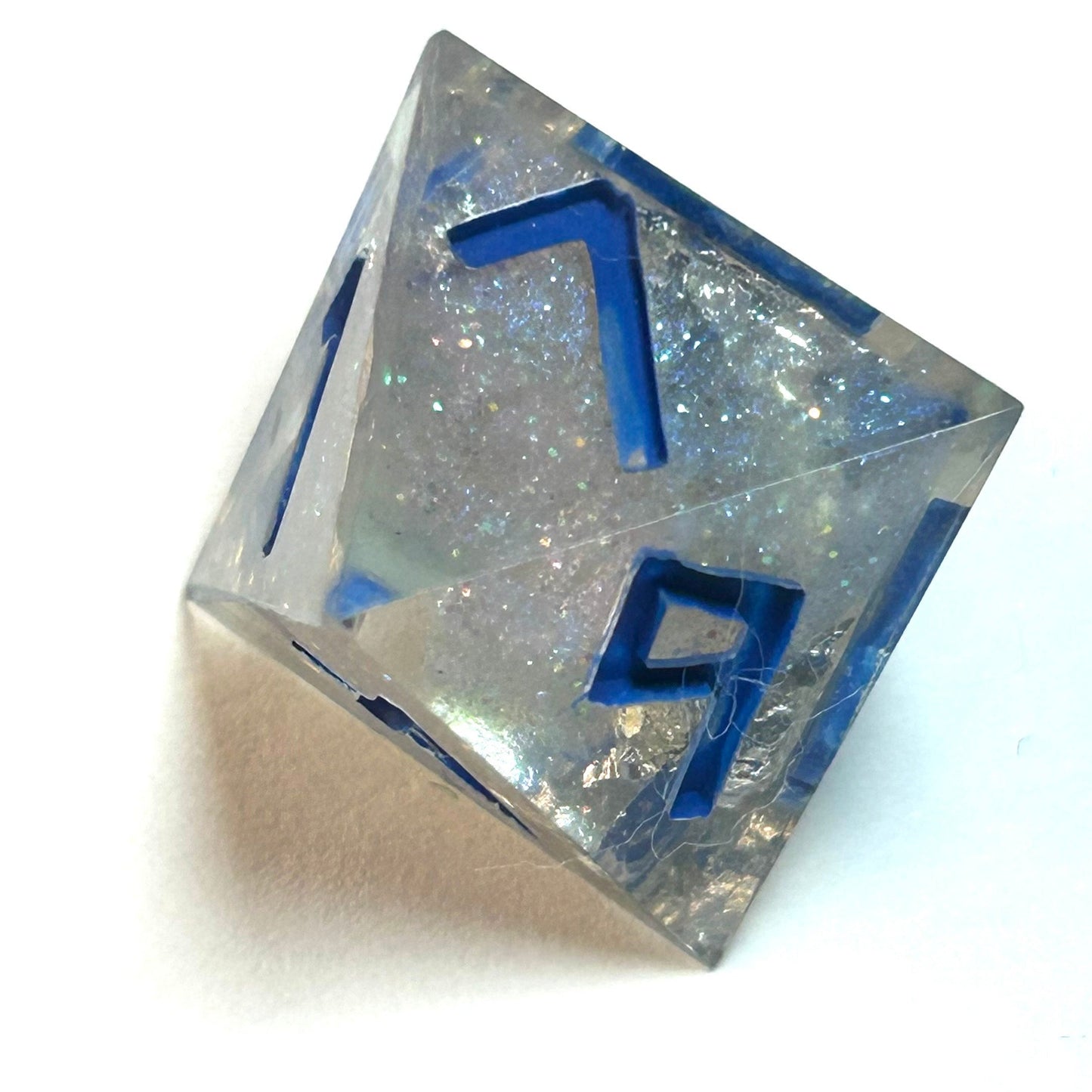Clear resin dice d8 with silver shimmer and deep blue numbering, resembling fractured ice — Infernal Crafts Glacial Veil handmade resin dice