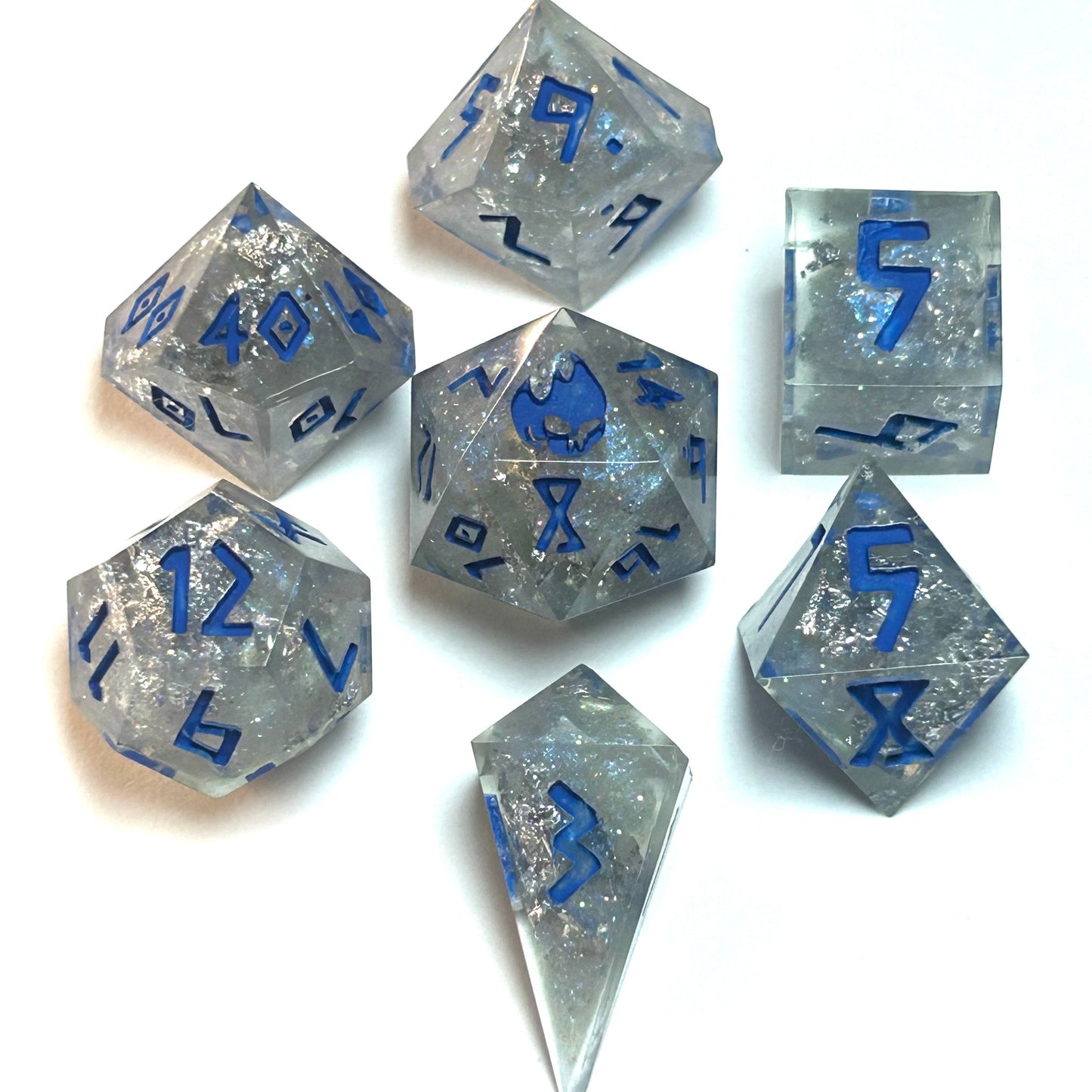 Clear resin dice set with silver shimmer and deep blue numbering, resembling fractured ice — Infernal Crafts Glacial Veil handmade resin dice set