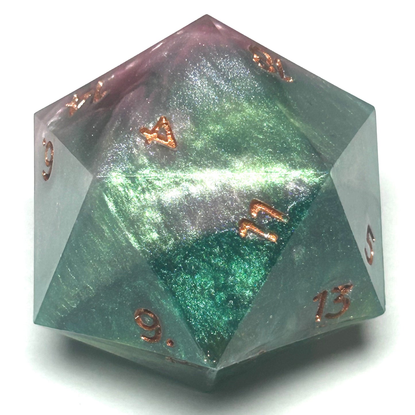 Oversized 40mm resin D20 die with shimmering green and gold swirls and copper numbering.