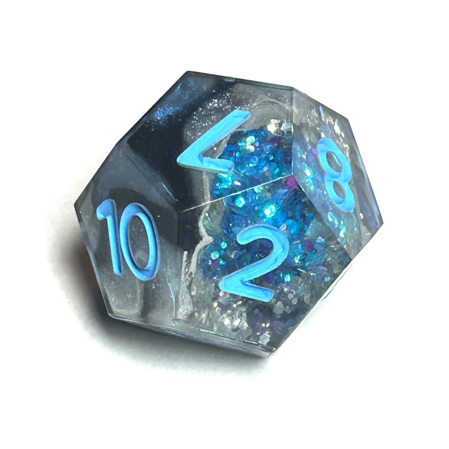 D20 geode dice with glitter and blue numbers on a white background
