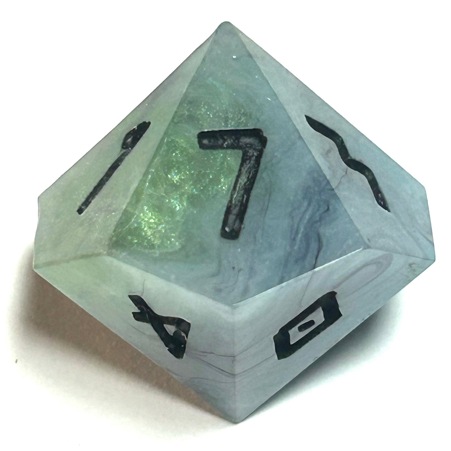 D10 die from the Mistbourne resin dice set, showing marbled gray and soft green resin with crisp black numbering
