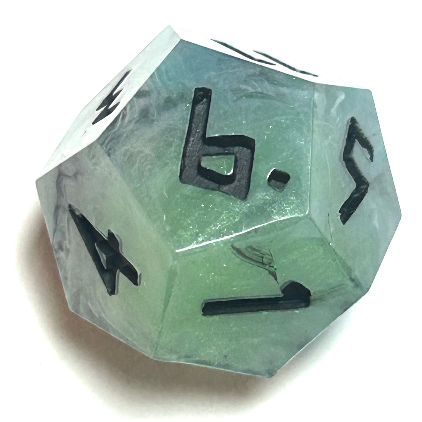 D12 die from the Mistbourne handmade resin dice set with smooth teal-gray swirls and black engraved numerals