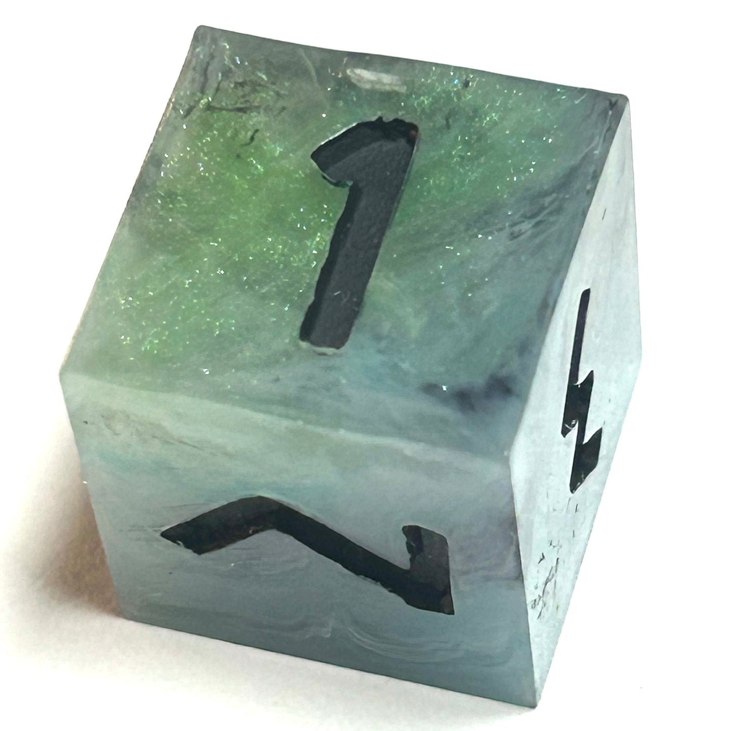 D6 die from the Mistbourne handmade resin dice set, featuring misty green and gray resin with bold black numbering