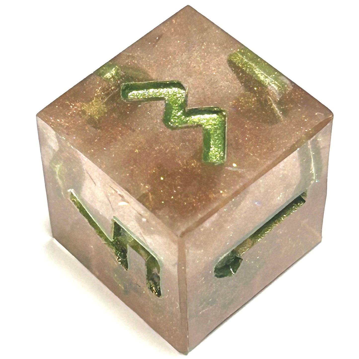 D6 die from the Verdigrace resin dice set, showing a soft rose-gold translucent resin and glowing green numbers