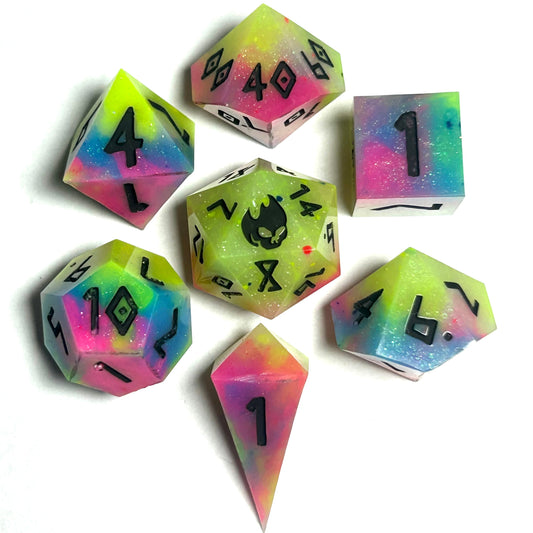 Handmade 7-piece neon rainbow resin dice set for Dungeons & Dragons, featuring bright yellow, pink, green, and blue swirls with black numbers.