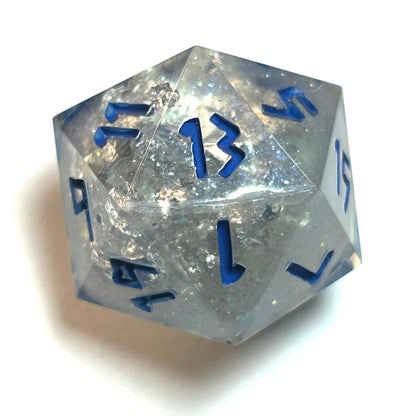 Clear resin d20 with silver shimmer and deep blue numbering, resembling fractured ice — Infernal Crafts Glacial Veil handmade resin dice