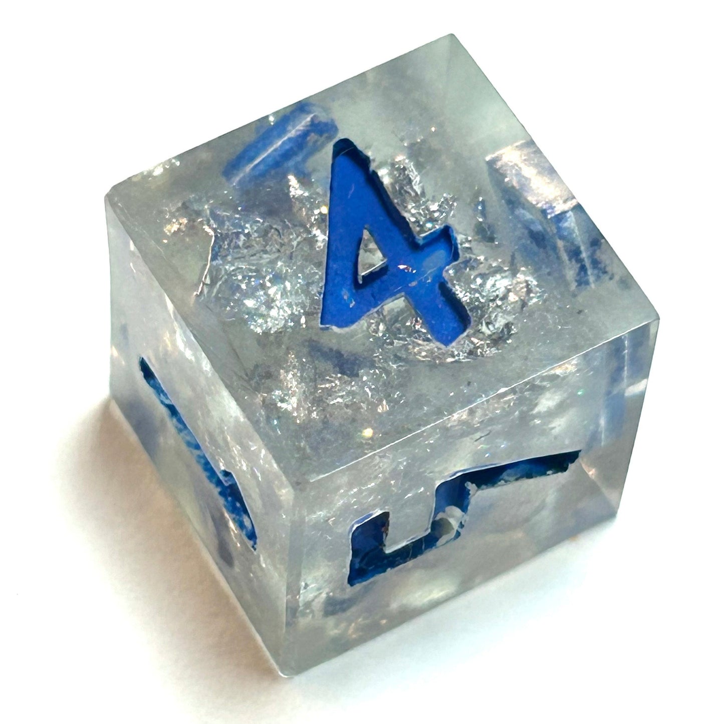 Clear resin dice d6 with silver shimmer and deep blue numbering, resembling fractured ice — Infernal Crafts Glacial Veil handmade resin dice set