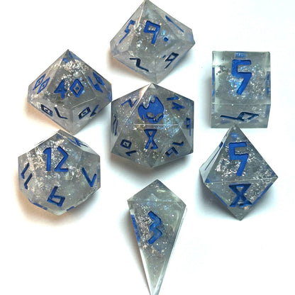 Clear resin dice set with silver shimmer and deep blue numbering, resembling fractured ice — Infernal Crafts Glacial Veil handmade resin dice set