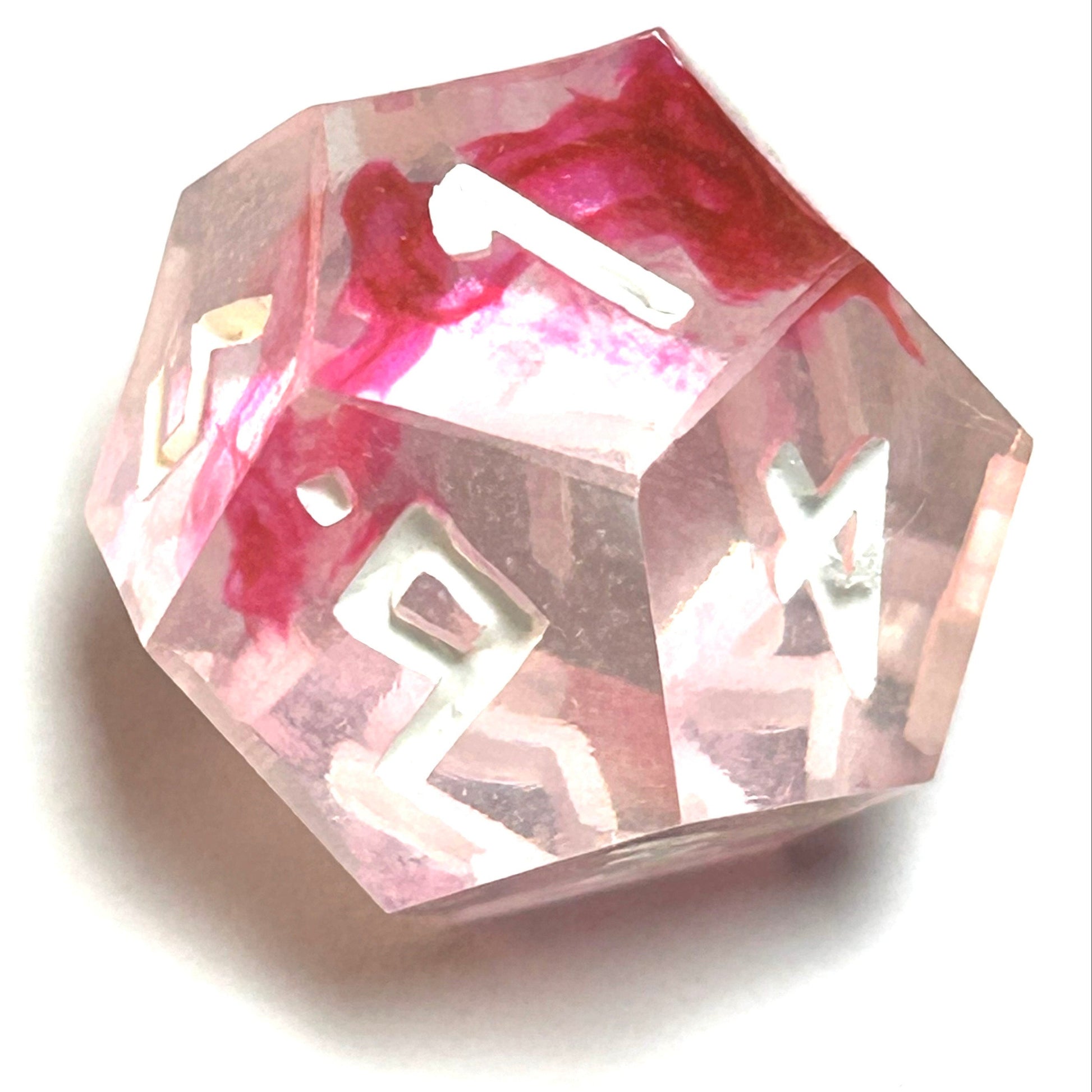 D12 die from the Heartbreaker handmade resin dice set with soft red swirls in clear resin and vivid white engraved numbers