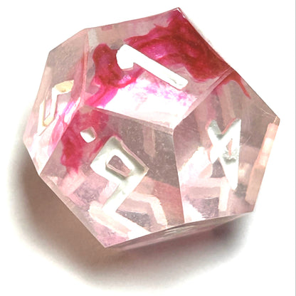 D12 die from the Heartbreaker handmade resin dice set with soft red swirls in clear resin and vivid white engraved numbers