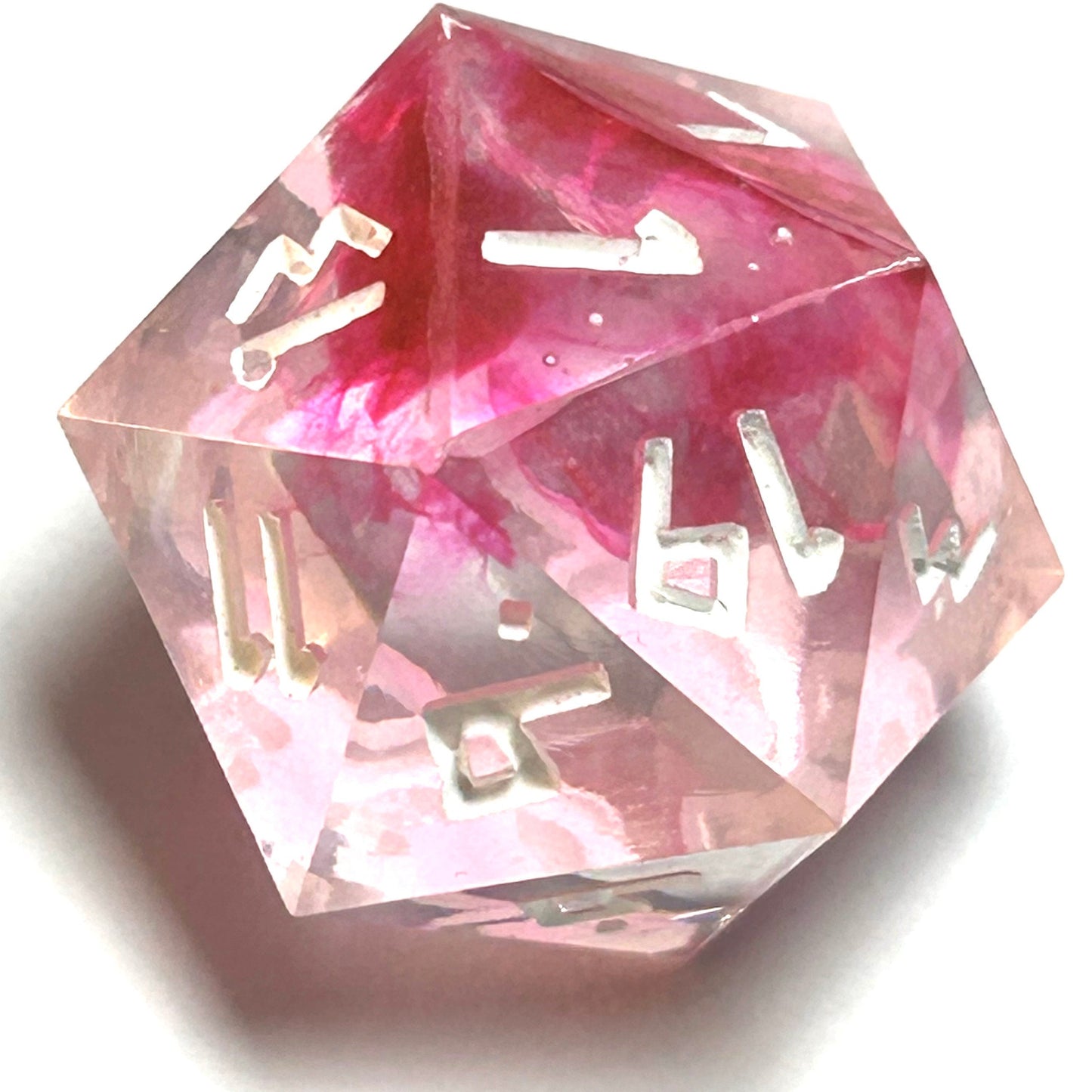 D20 die from the Heartbreaker resin dice set showing intense crimson color flowing through transparent resin with crisp white numbers