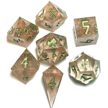 Verdigrace handmade resin dice set featuring a rose-gold shimmer base with bright green numbering — full 7-piece polyhedral set by Infernal Crafts